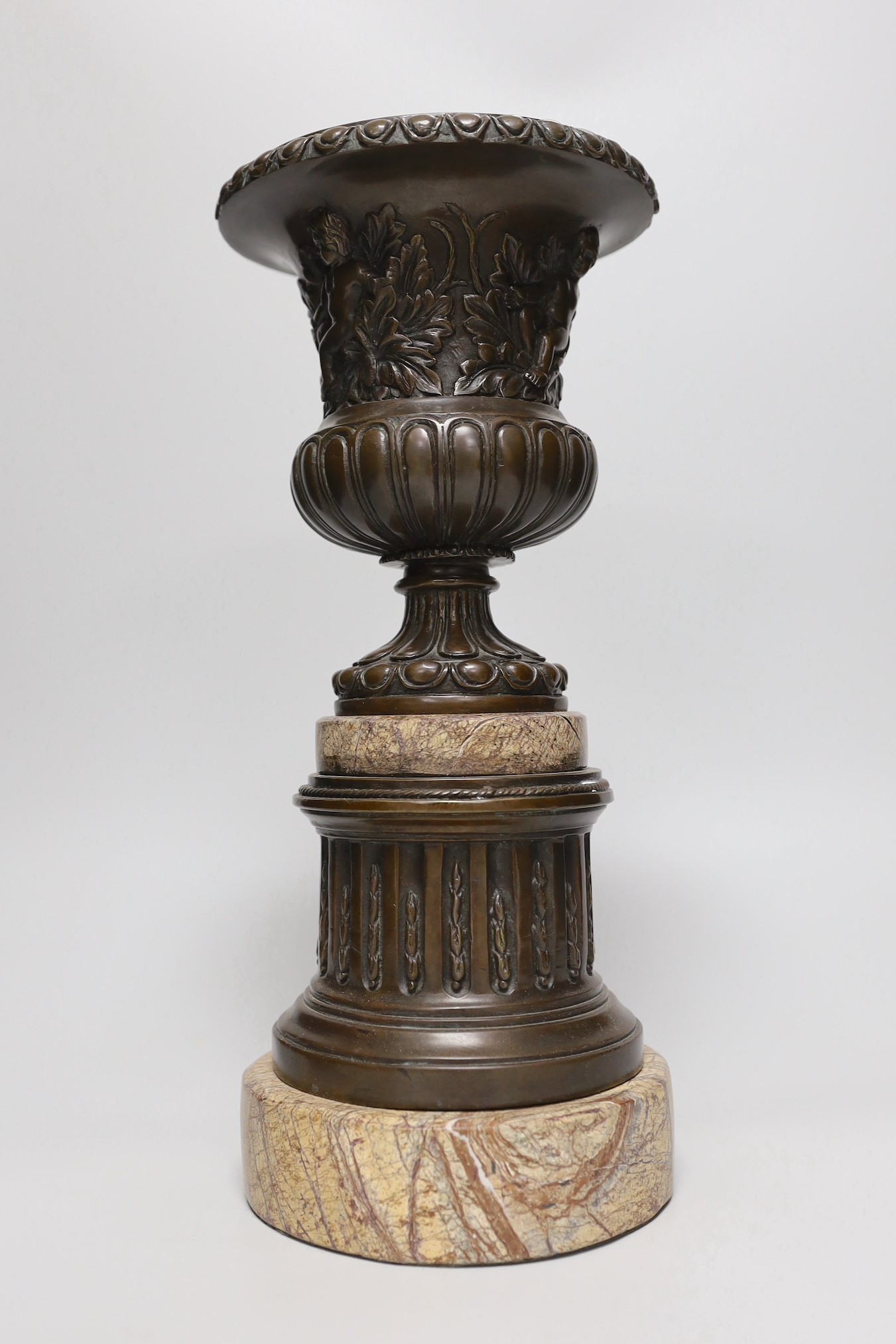 A classical revival bronze and serpentine urn and pedestal, 33cms high